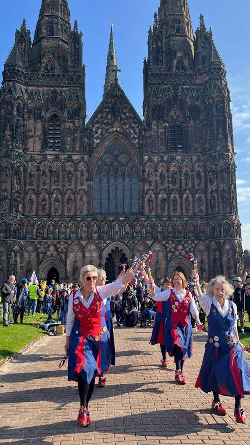 dancing in front of the impressive facade of the cathedral